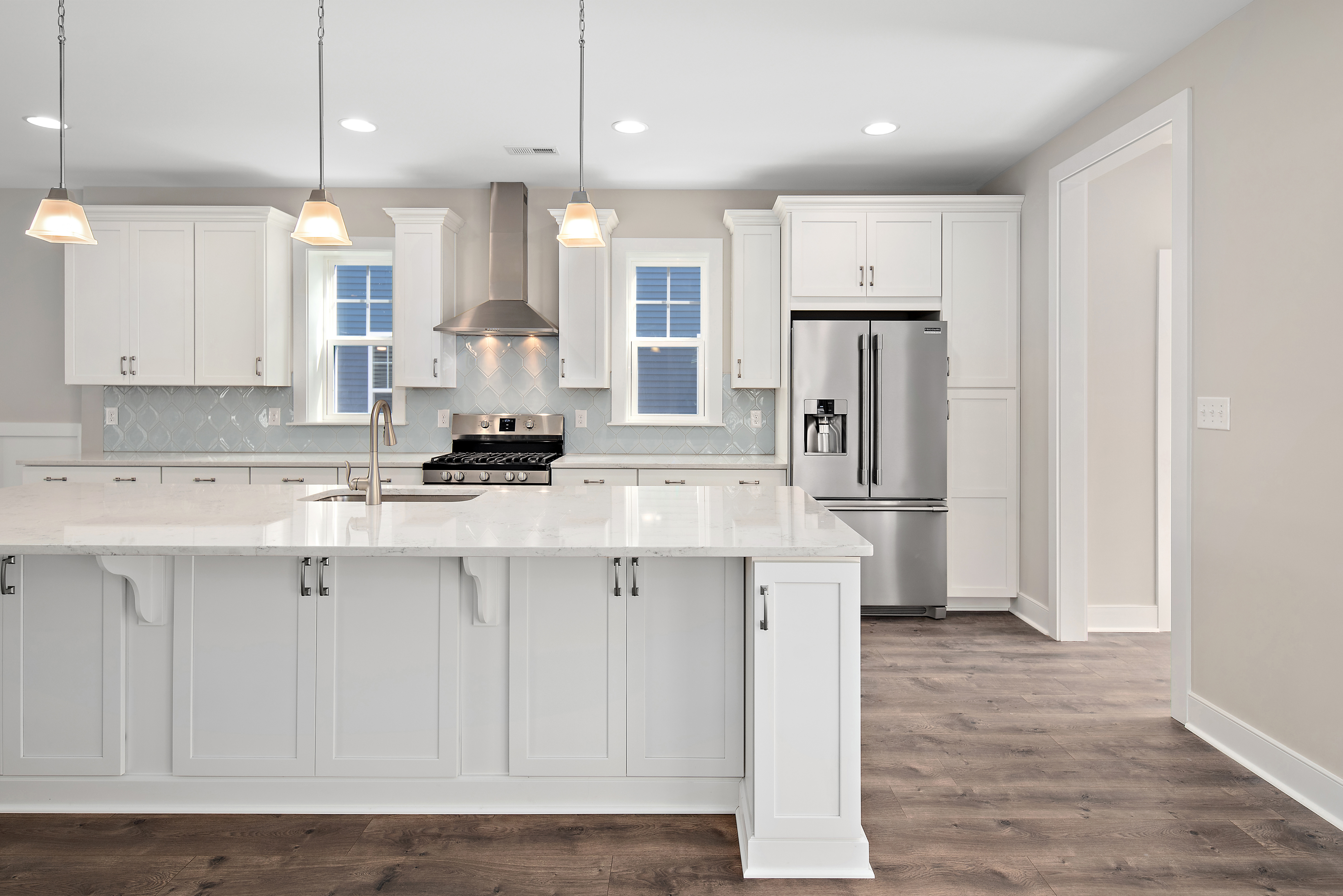 Gourmet kitchen with large center island in custom built home by Evergreene Homes