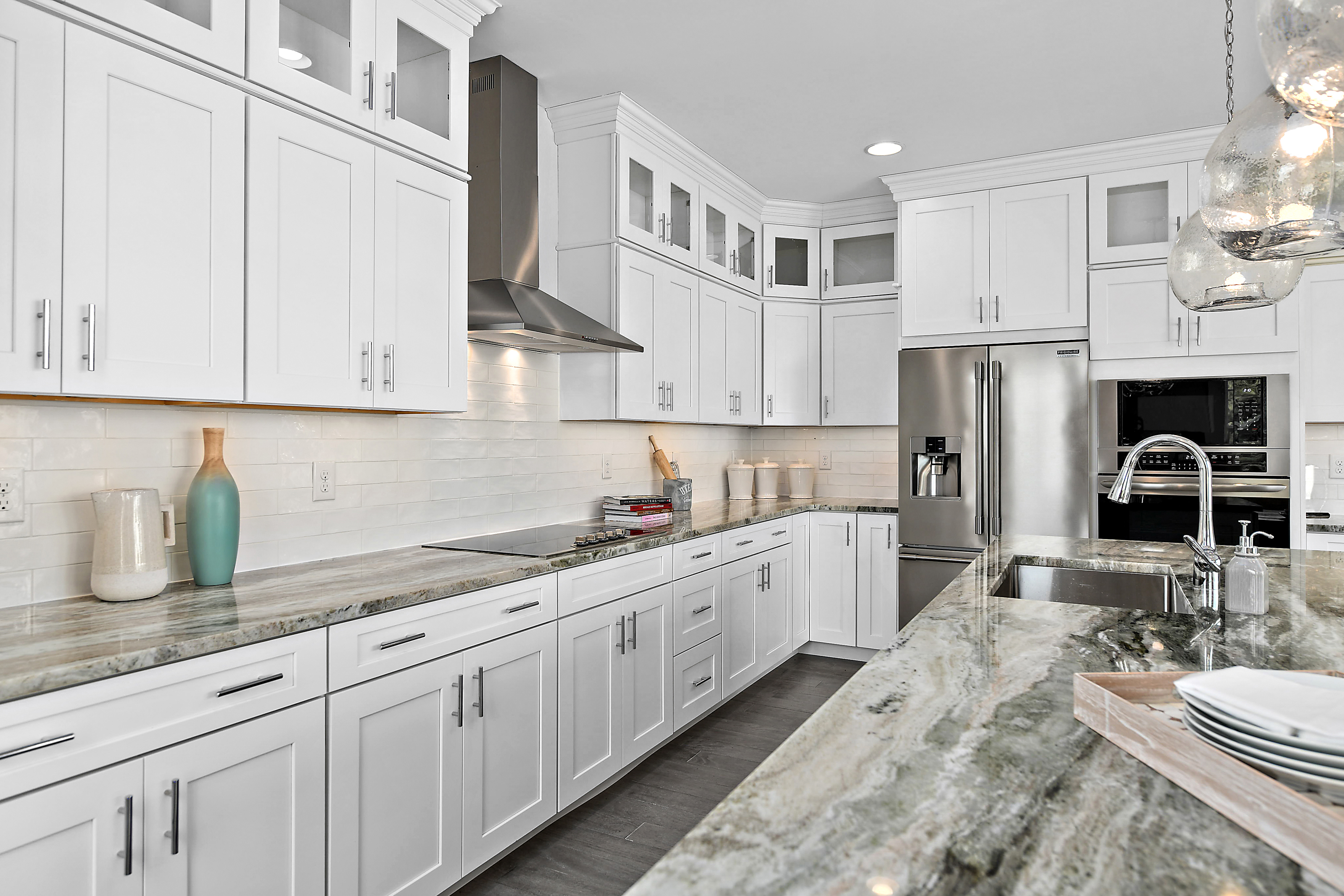 Gourmet Kitchen with White Cabinets, Glass Double Stacked Cabinets, Granite Counters, and Stainless Steel Appliances