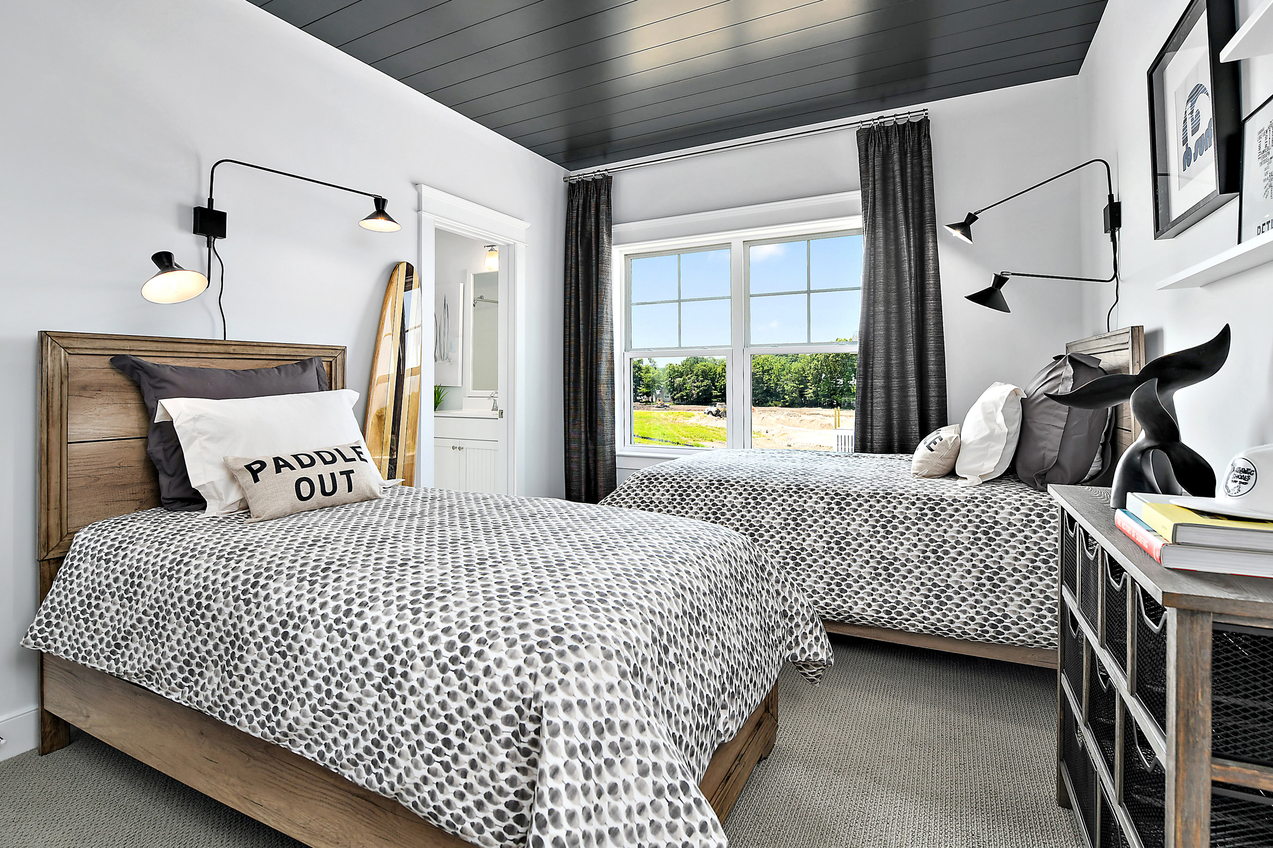 Guest Room Featuring Two Twin Beds with Carpet and Shiplap Treatment on Ceiling