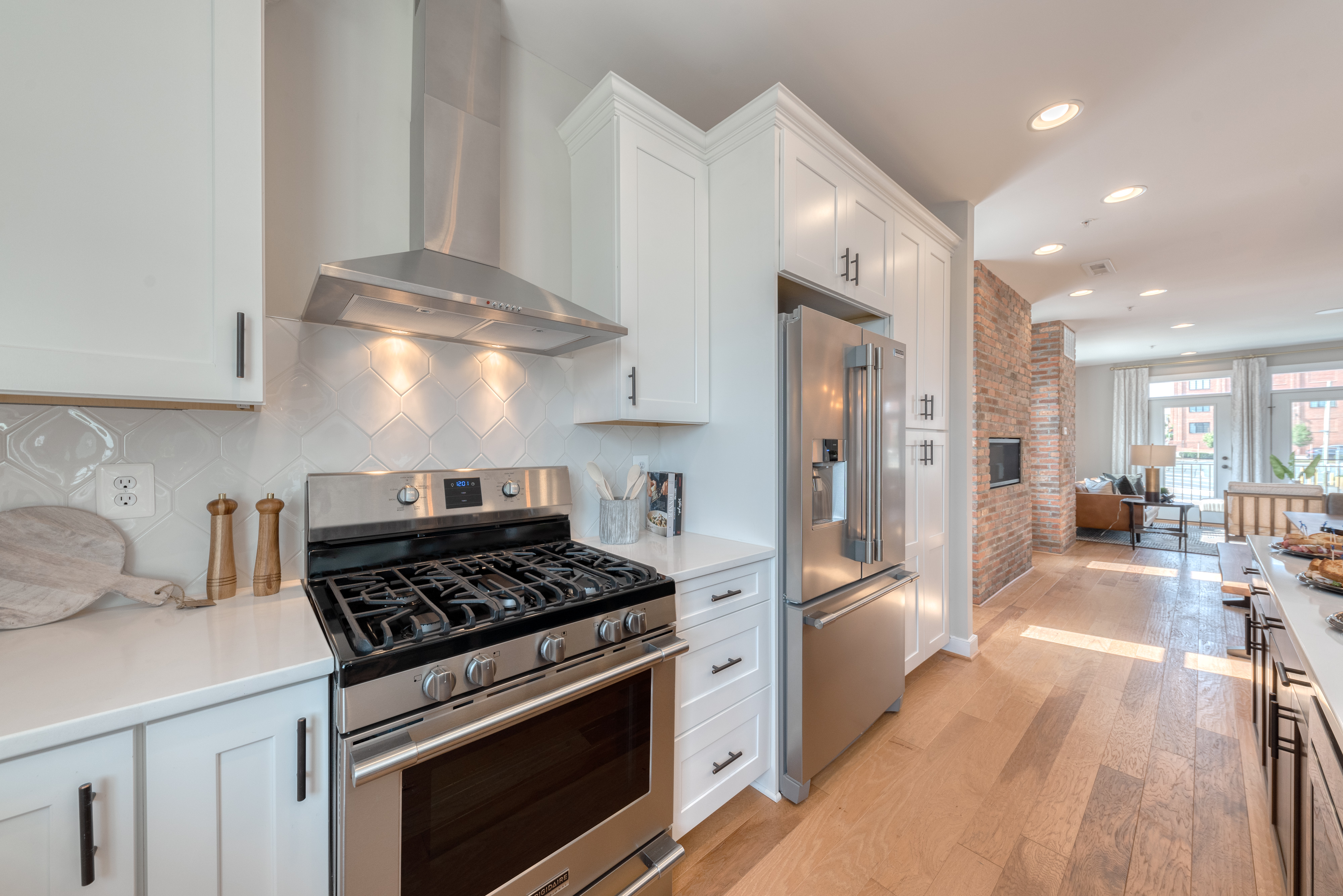 Gourmet Kitchen with White Cabinets, Quartz Countertops, and Stainless Steel Appliances
