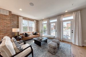 Open Concept Living Area with Couches, Coffee Table and large Exterior Windows