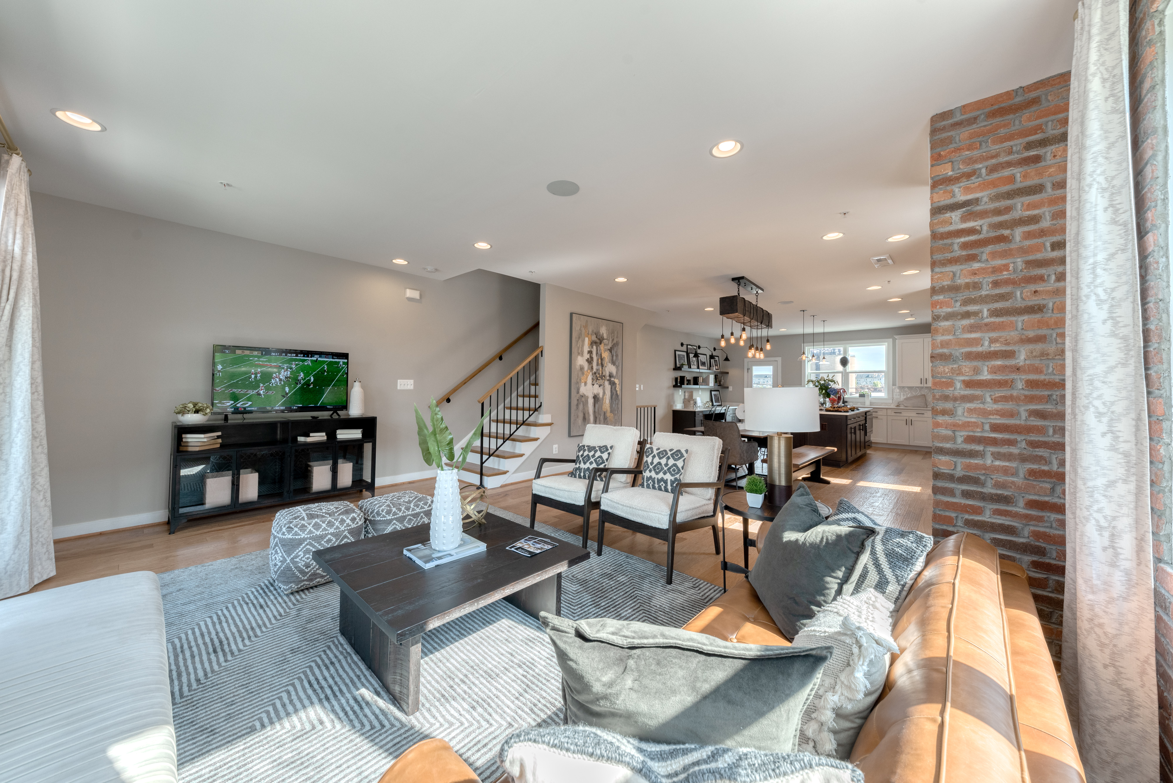 Open Concept Living Area with Couches, Coffee Table and Television