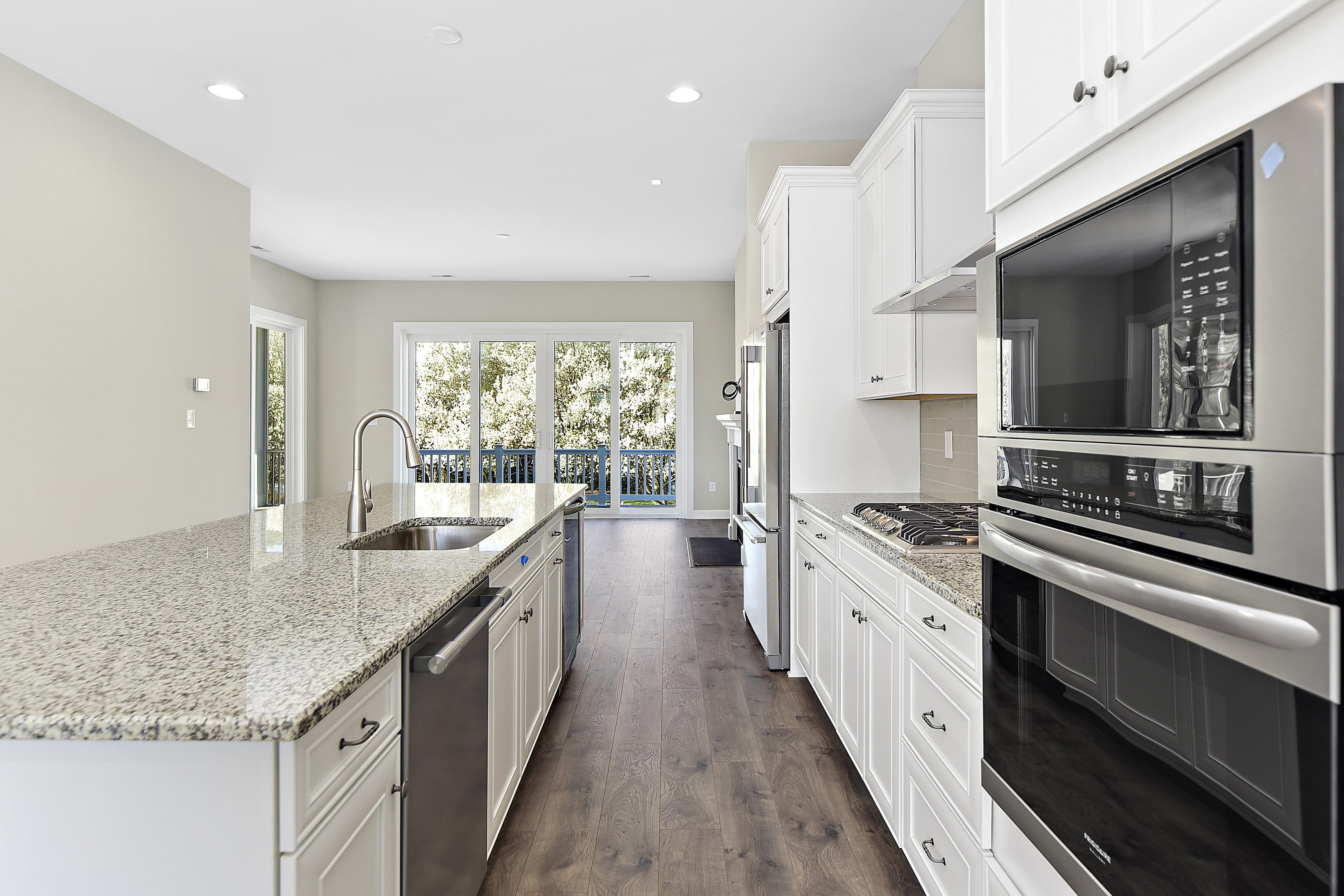 Oven, dishwasher and large kitchen island in kitchen of Turnstone home