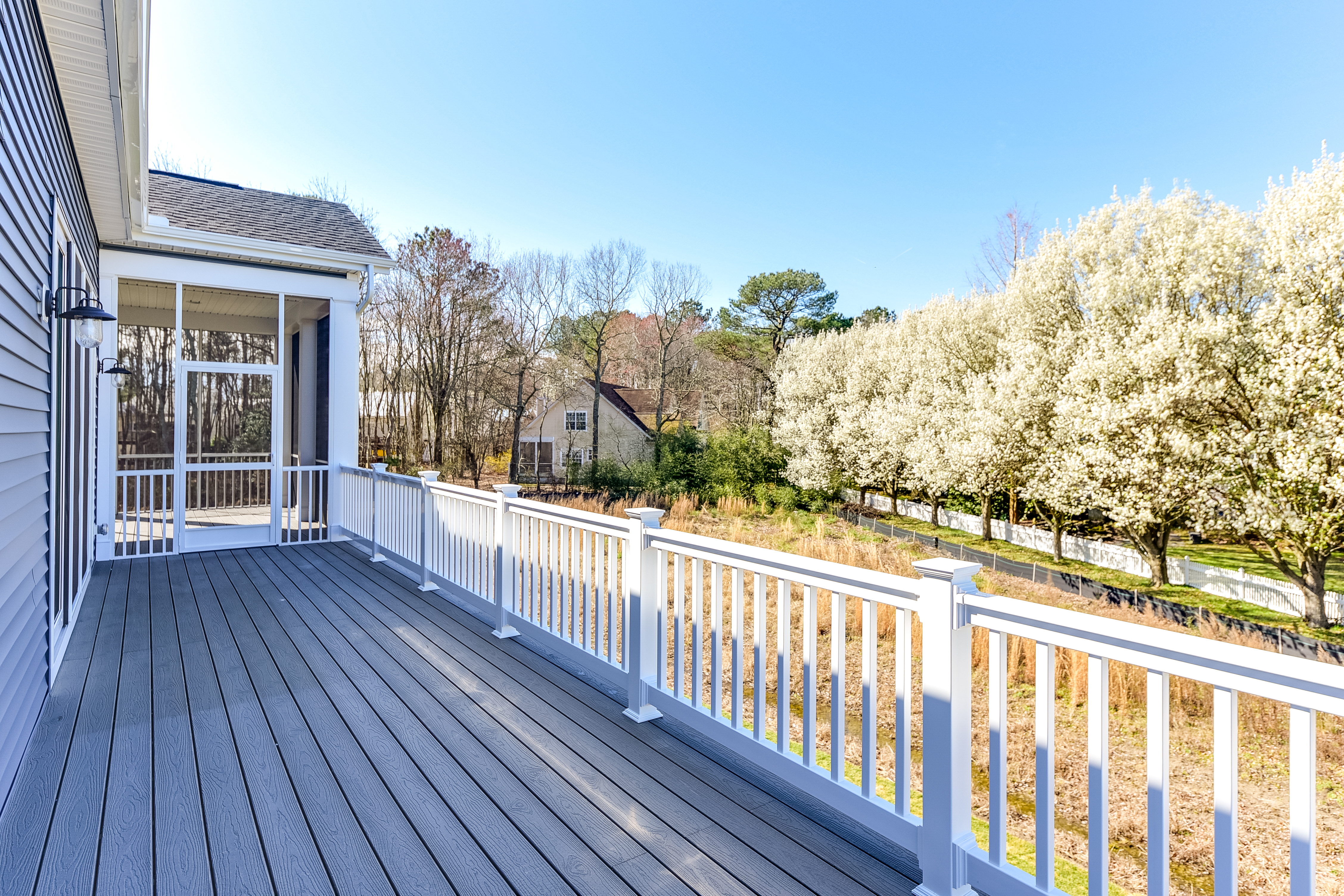 Spacious rear deck overlooking wooded area