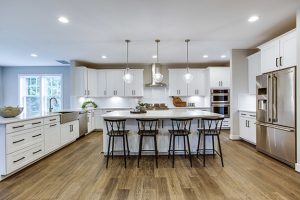 Luxury kitchen with white cabinets and large center island in Virginia Evergreene Home