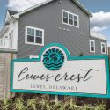 Lewes Crest community sign and attractive townhome exterior