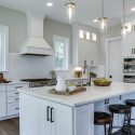 Large kitchen with center island and white cabinets in Camdyn floorplan