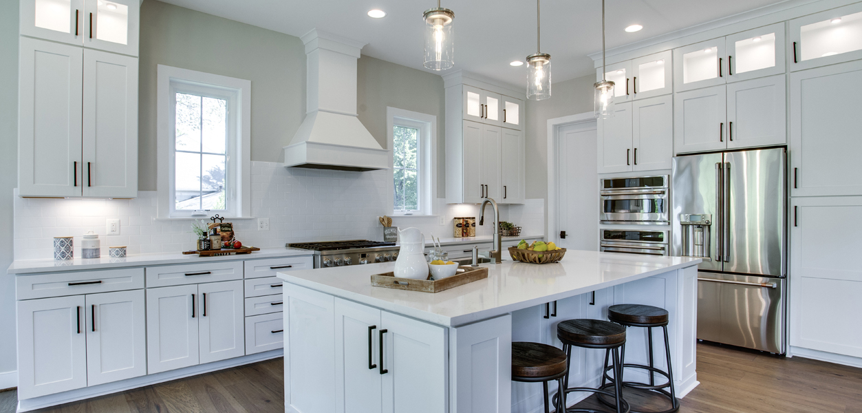 Large kitchen with center island and white cabinets in Camdyn floorplan