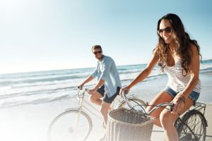 Couple biking on the beach in Delaware