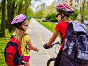 Bikes,Bicyclist,Girl.,Girls,Wearing,Bicycle,Helmet,And,Rucksack,Ciclyng