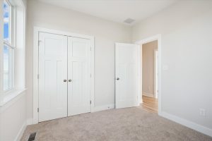 Cozy secondary bedroom with modern decor in the Linwood floor plan.