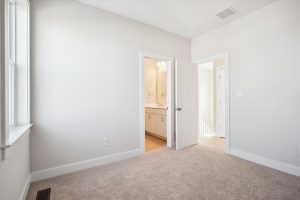 Modern secondary bedroom with neutral tones in the Linwood floor plan.