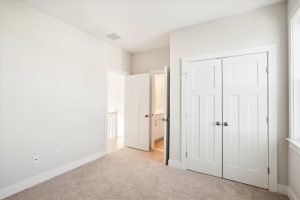 Cozy secondary bedroom with modern decor in the Linwood floor plan.