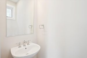 Modern powder room with sleek fixtures in the Linwood floor plan.