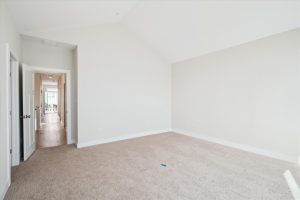 Spacious primary bedroom with modern decor in the Linwood floor plan.