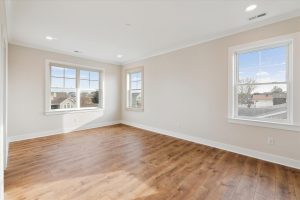 Cozy primary bedroom with large windows in the Shearwater floor plan.