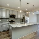 Chef kitchen in Harrison duplex at Preston Lake by Evergreene Homes