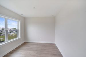 Open-concept living area with contemporary furniture in the Magnolia floor plan.