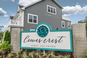 Lewes Crest community sign and attractive townhome exterior