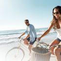 couple-biking-on-beach Couple biking on the beach in Delaware