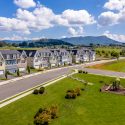 Row of single family homes at Preston Lake community overlooking scenic hills