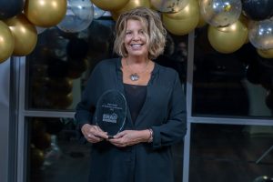 Team member of Evergreene Homes holding award for new home communities in Delaware in 2022