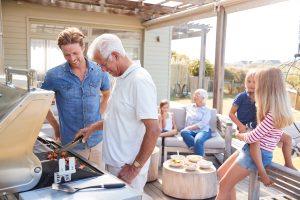 Multi,Generation,Family,Enjoying,Cooking,Barbecue,At,Home